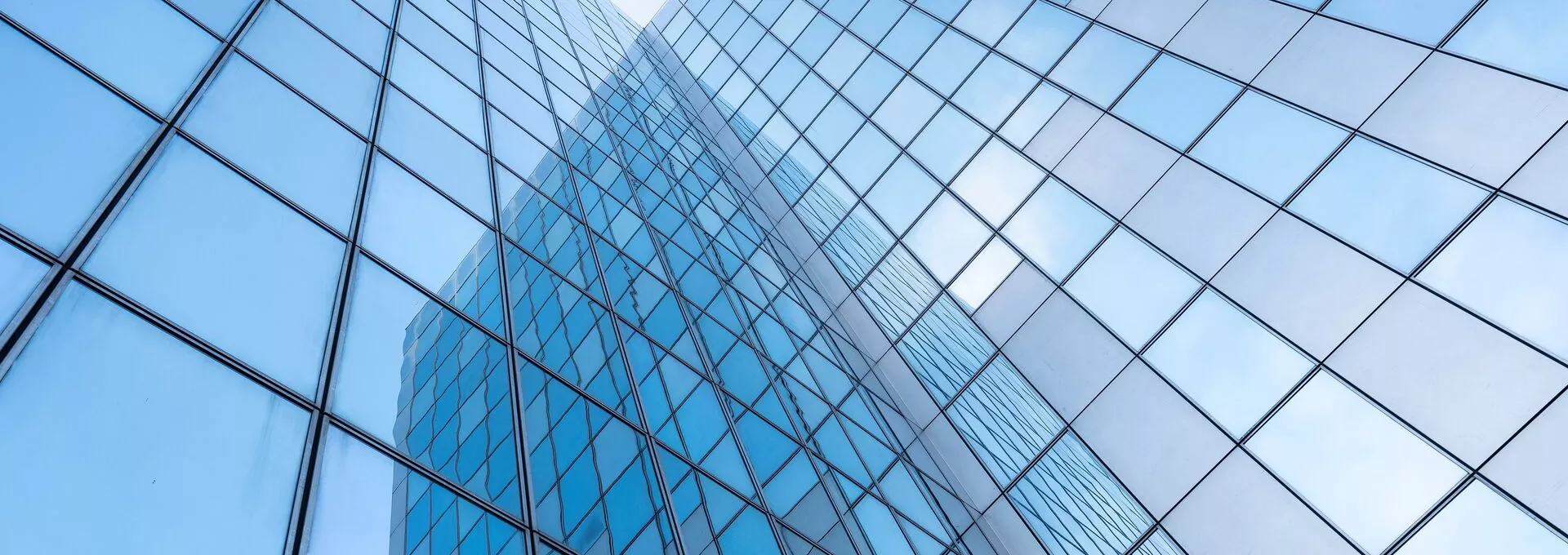 glass facades of modern office buildings and reflection of blue sky