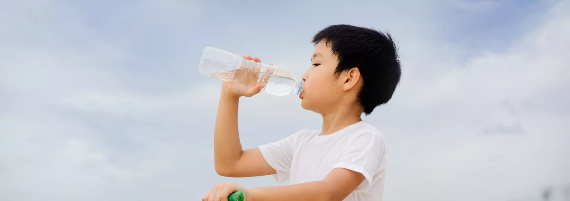 Little guy drinking water in a bottle