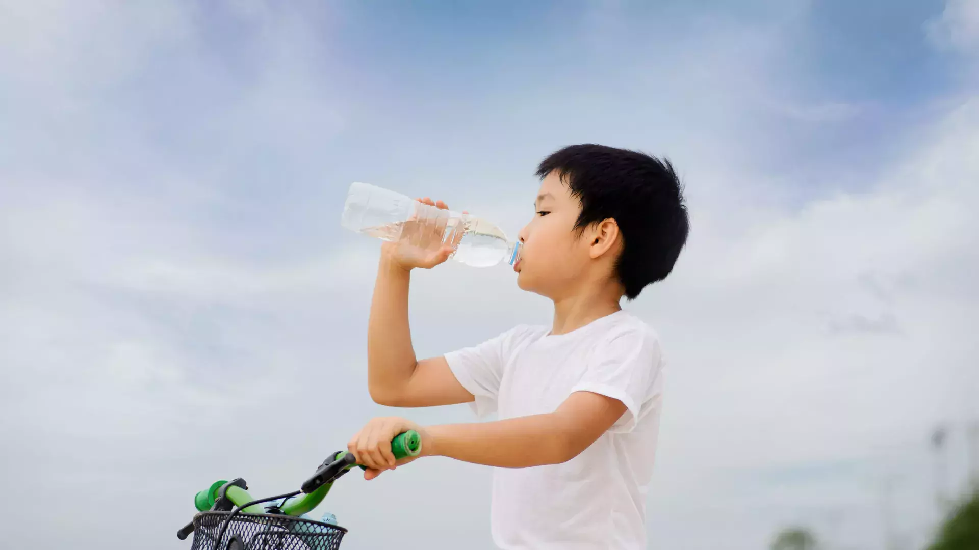 Little guy drinking water in a bottle