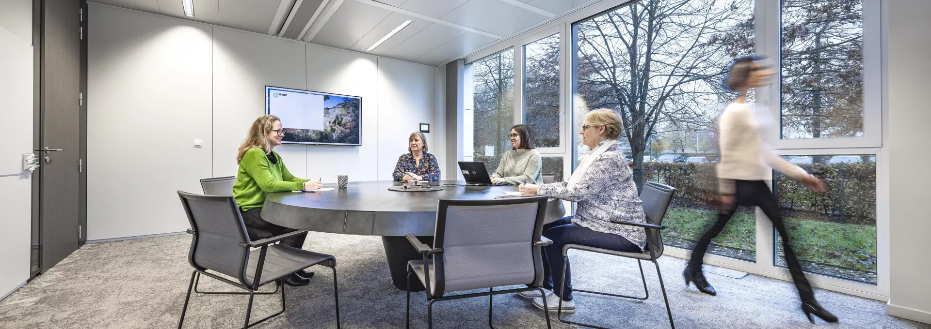 People working around a table in conference room 