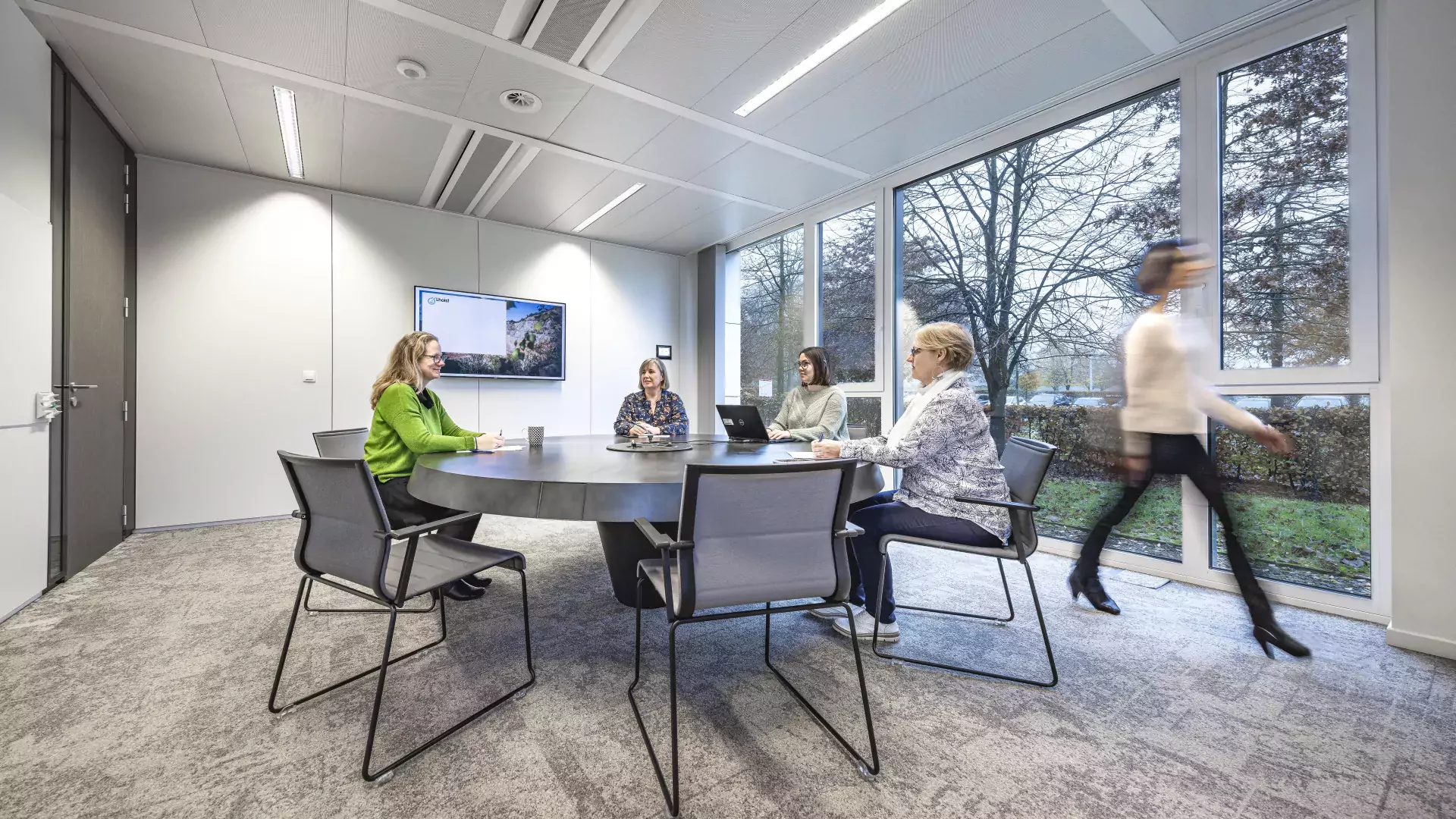 People working around a table in conference room 