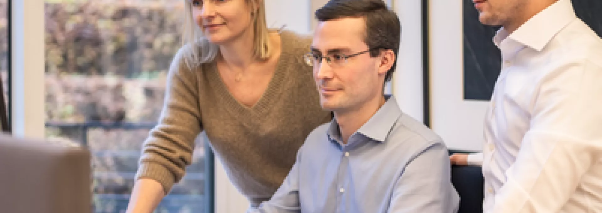 Group of people working in front a computer