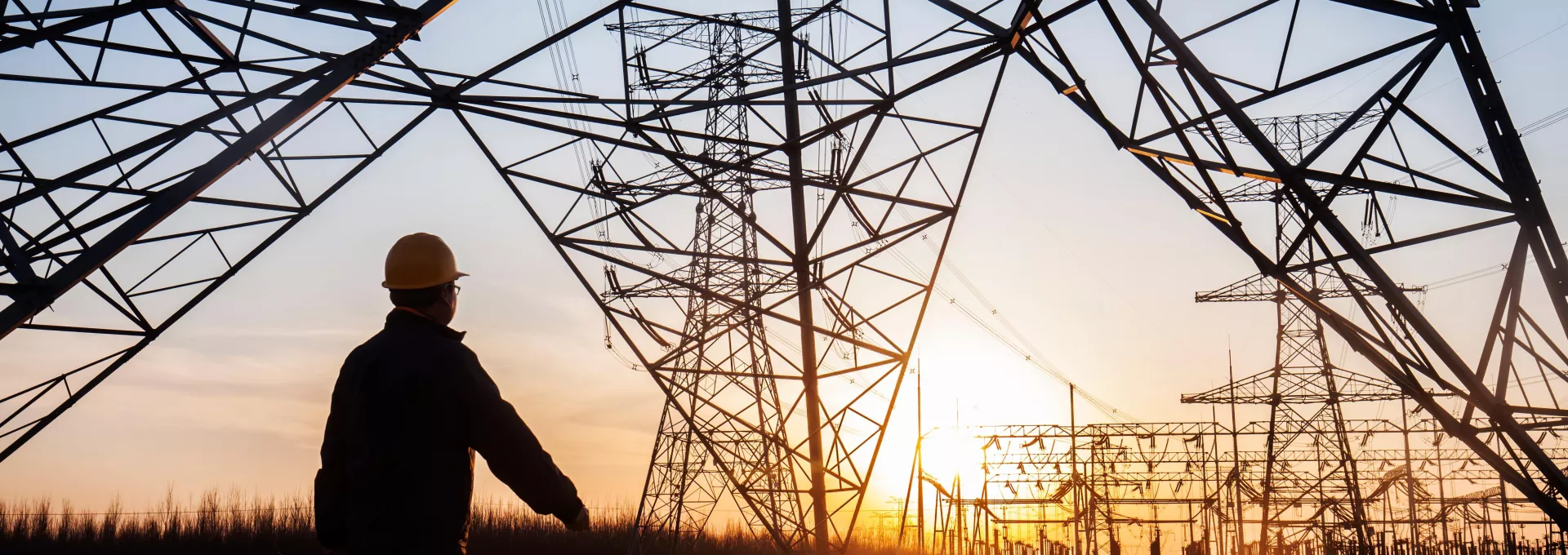 electricity workers and pylon silhouette