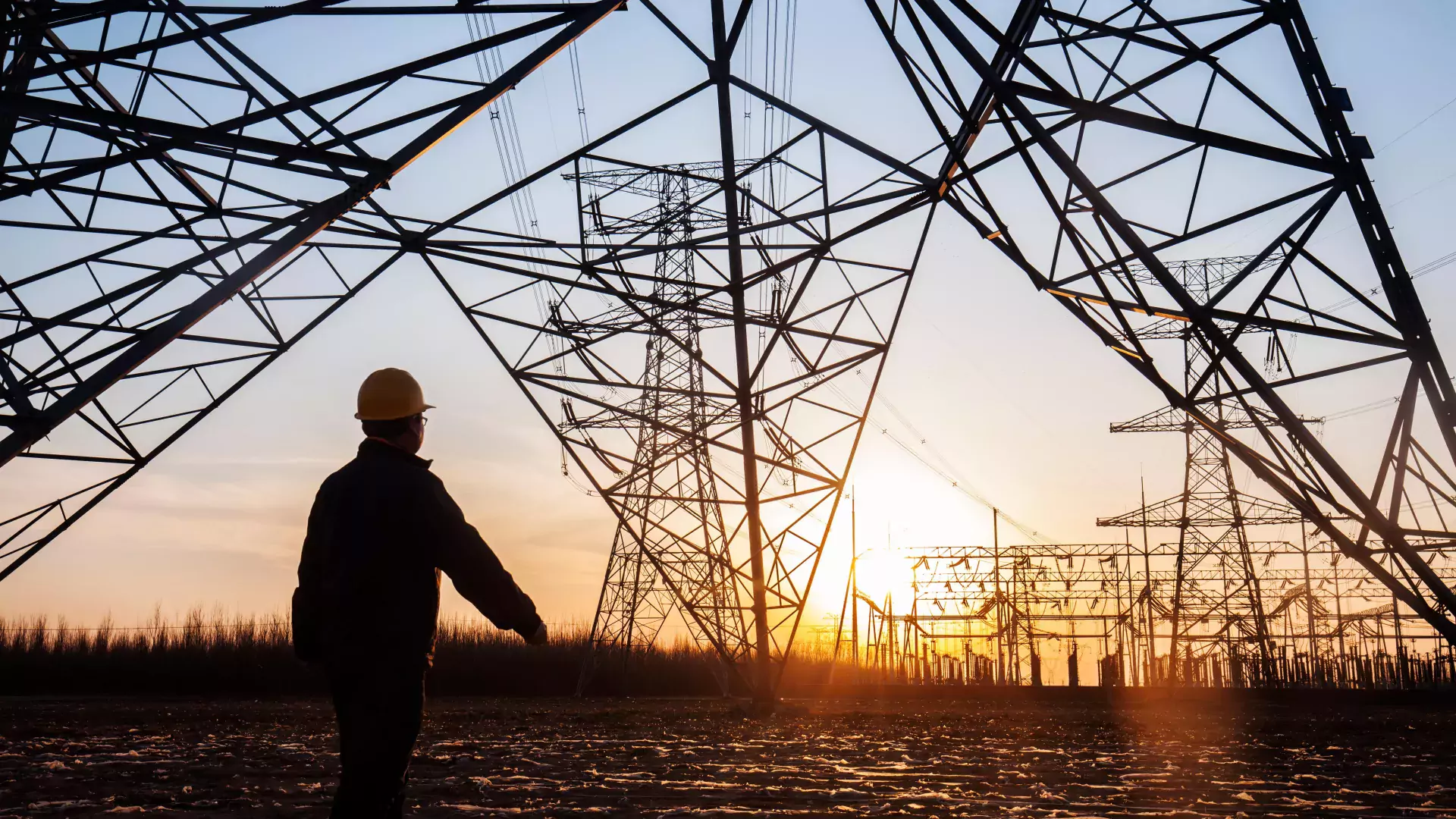 electricity workers and pylon silhouette