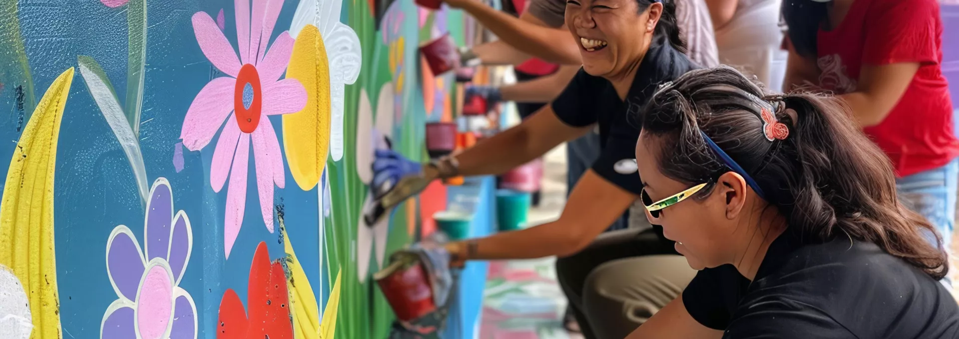 people drawing on a wall as community action