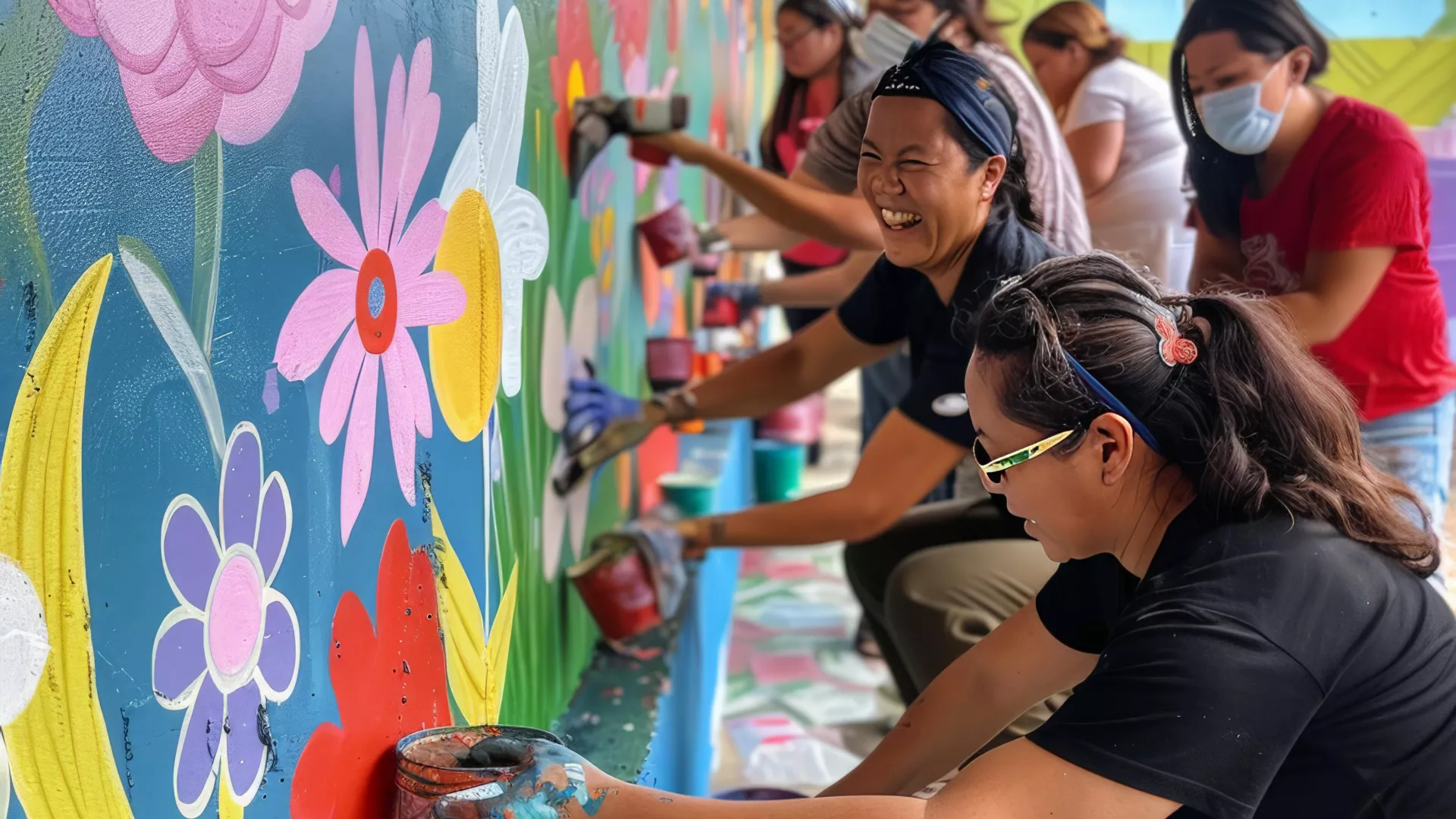 people drawing on a wall as community action