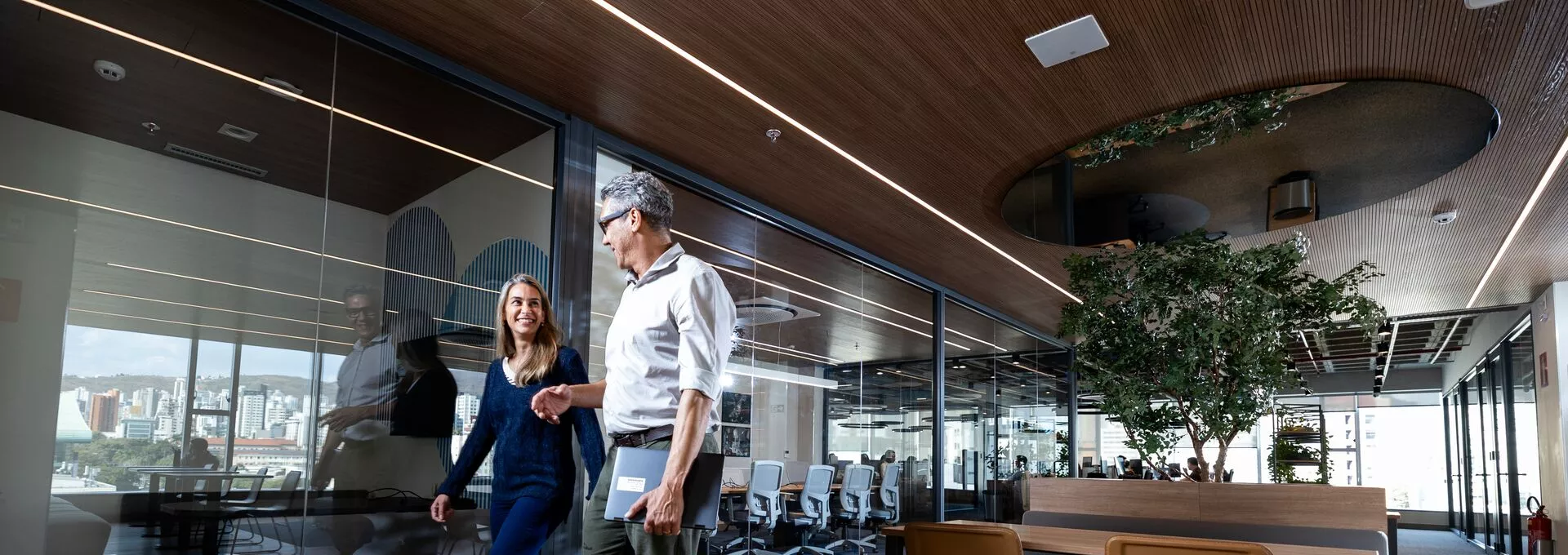 Two people walking in an office