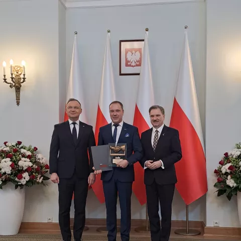 Three people receiving an award