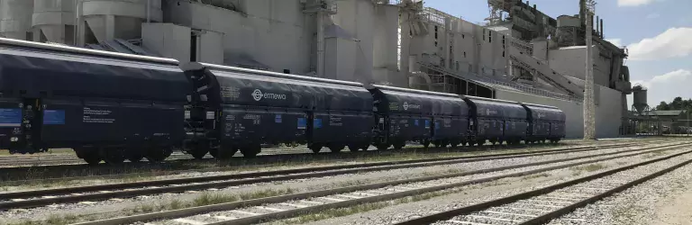 Blue rail car on train tracks