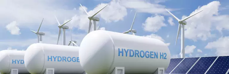 Hydrogen tanks in front of solar panels and wind mills