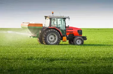tractor fertilizing a field