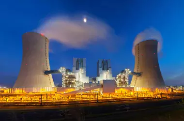 Panoramic wide angle shot of a modern brown coal power station with night blue evening sky