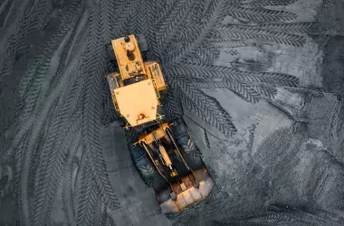 tractor leaving tracks on a coal ash field