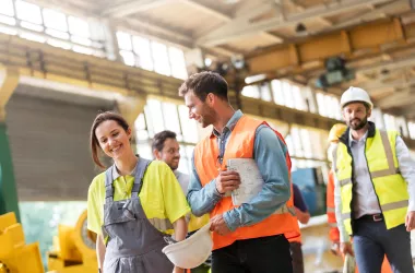 Steel workers walking and talking in a plant