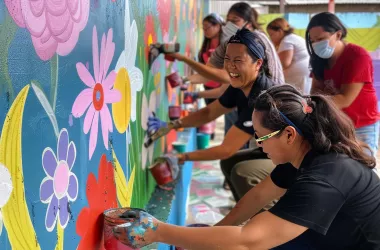 people drawing on a wall as community action