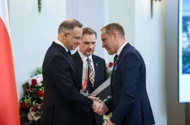 Three people receiving an award