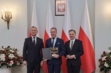 Three people receiving an award