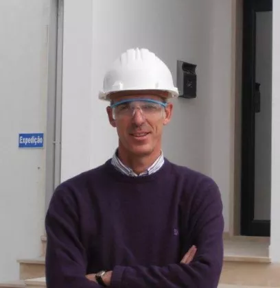 man with helmet in front of building