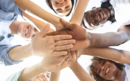 group of people stacking hands together