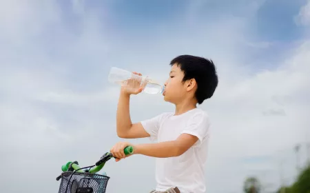 Little guy drinking water in a bottle