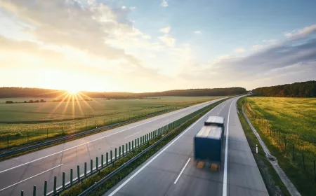 Delivery truck on road with sunset