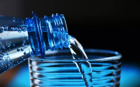 bottle filling a glass of water