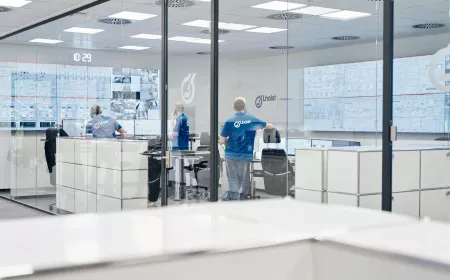 People in office in white and blue colours with screens