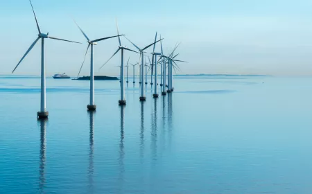 Wind mills on the sea with blue sky