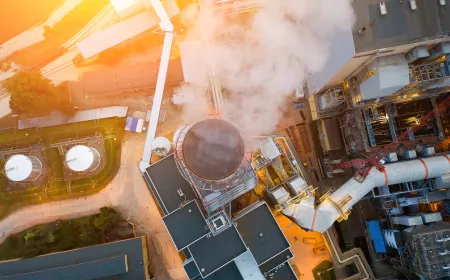 View from the top with smoke comes out of the chimneys of the power plant