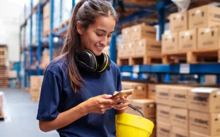 woman in warehouse with mobile phone