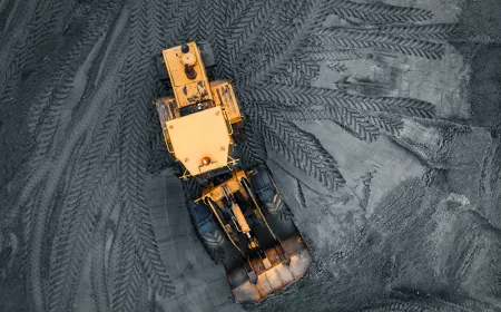tractor leaving tracks on a coal ash field