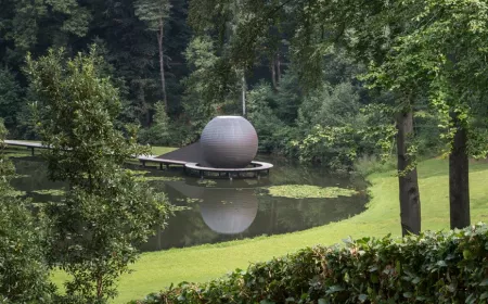 overview of a green park with round structure in the center