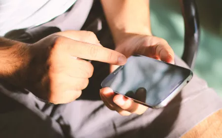 Someone touching his mobile phone glass screen