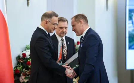 Three people receiving an award