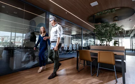 Two business people walking in an office