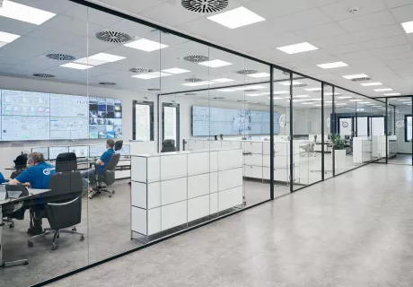People in office in white and blue colours with screens